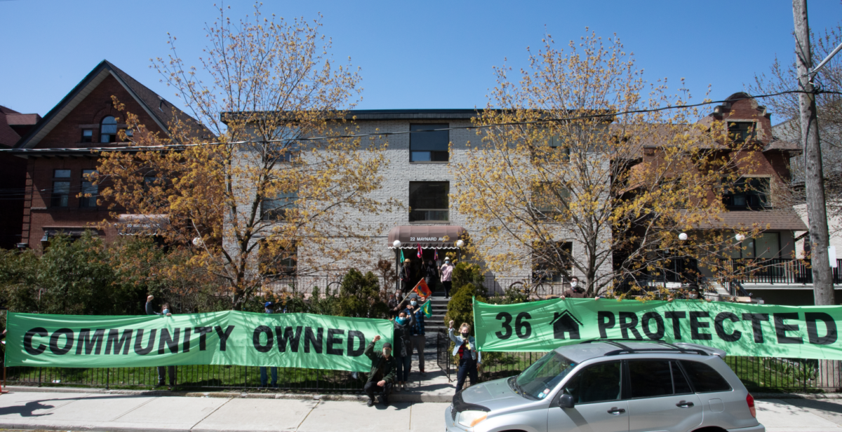 Parkdale Neighbourhood Land Trust banner in front of one of their apartment buildings